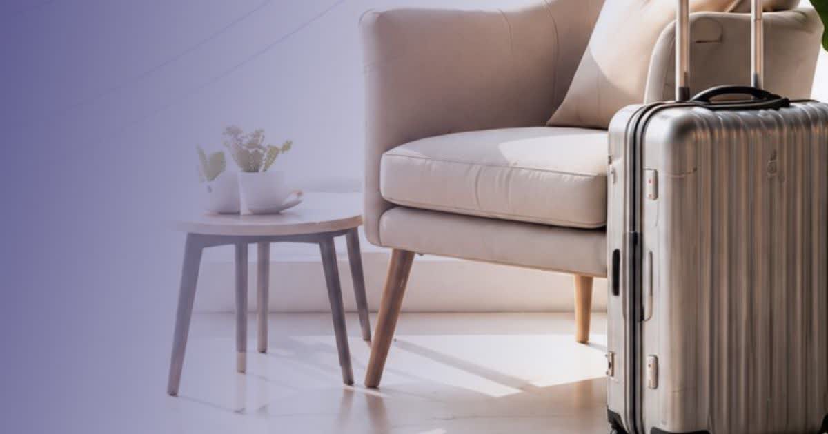 Suitcase next to an armchair in a bright airport waiting area
